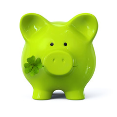 Green piggy bank with four leaf clover