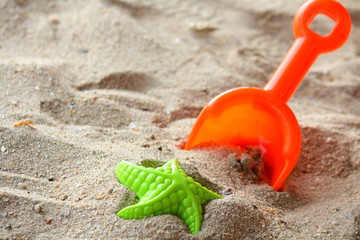 Fototapeta na wymiar Children's beach toys on sand