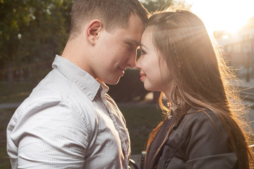 Fototapeta premium couple in backlit at sunset in town