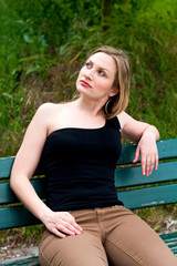 woman sitting on the bench in park