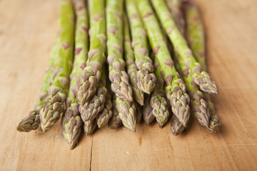 Bunch of fresh green asparagus on wooden background