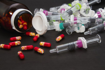 Pills  and medical syringes