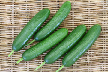 Little cucumbers on wicker background