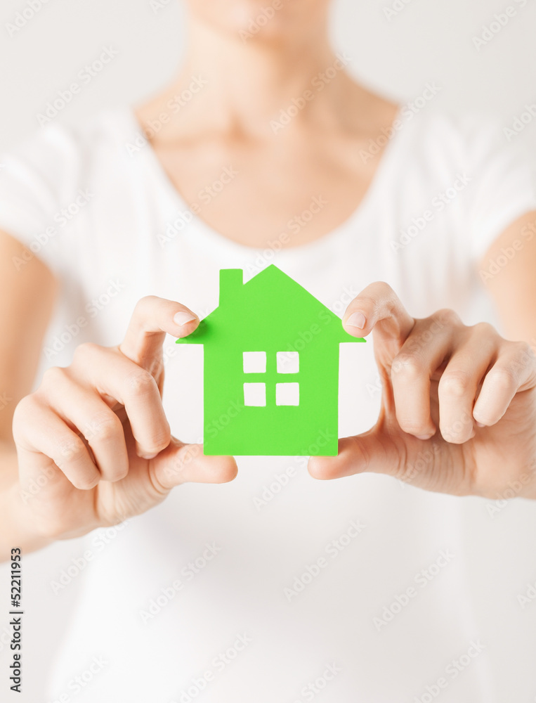 Poster woman hands holding green house