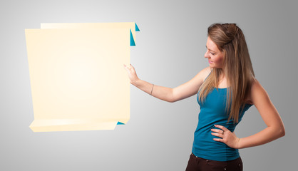 Young woman holding white origami paper copy space