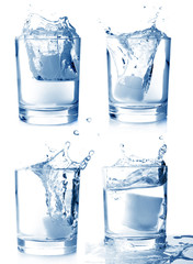 Ice in glass of water with splash set on white background .