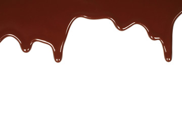 Melted chocolate dripping on white background .