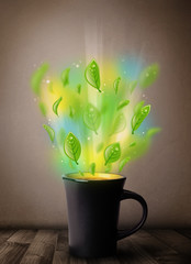 Tea cup with leaves and colorful abstract lights