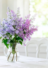 bunch lilac in vase on table