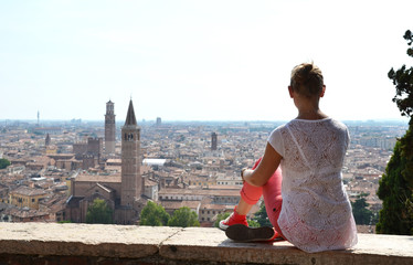 Girl looking to Verona town, Italy