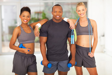 group of diversity people holding various gym equipment