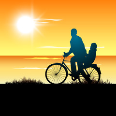 Fototapeta na wymiar Silhouette of a father and his child go for cycle ride at sunse