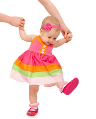 first steps of a beautiful cute baby girl with  hand of mother i