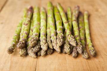 Bunch of fresh green asparagus on wooden background