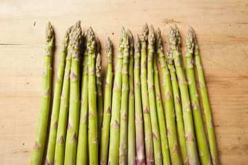 Bunch of fresh green asparagus on wooden background