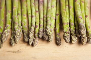 Bunch of fresh green asparagus on wooden background