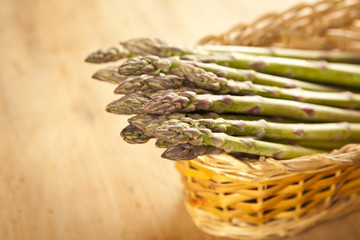 Bunch of fresh green asparagus on wooden background