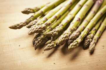 Bunch of fresh green asparagus on wooden background