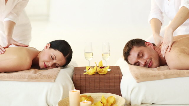 happy couple relaxing in spa salon