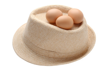 eggs on beige fabric hat isolate on white background