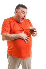 Portrait of a thirsty fat man staring at a glass of beer