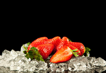 strawberry on black background.  strawberries with ice cubes on