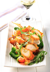 Breaded chicken breast with salad greens