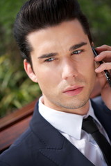 Portrait of a handsome young businessman on phone