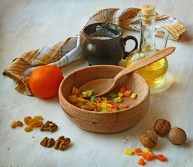 Candied fruits, nuts, olive oil and flour on a cook-table. Ingre