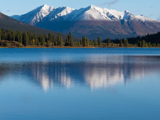 Snowcapped mountain reflection on Lapie Lake Yukon
