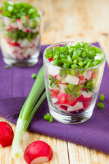 Fresh vegetable salad with radish in transparent glass