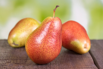 ripe pears on old wooden board