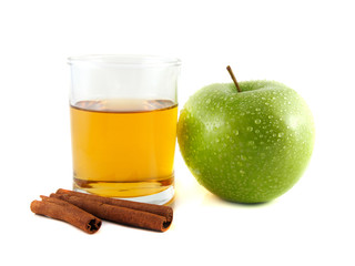 Green apple and glass of juice with cinnamon