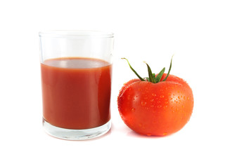 Red ripe tomato with glass of tomato juice (wet)
