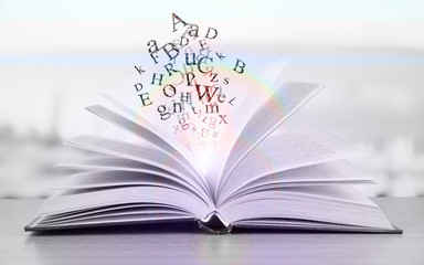 Opened book on bright background