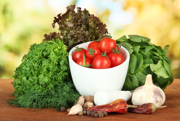 Composition of mortar, spices, tomatoes and  green herbs,