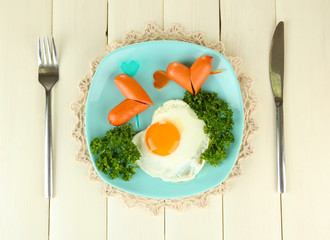 Sausages in form of hearts, scrambled eggs and parsley,