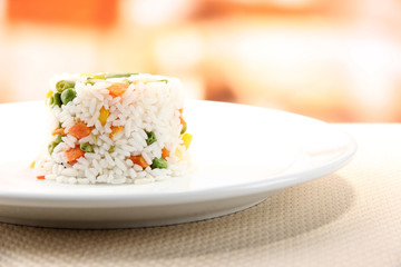 Delicious risotto with vegetables on table in cafe