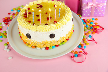 Happy birthday cake and gifts, on pink background