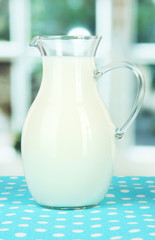 Pitcher of milk on table in room