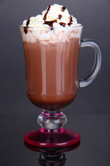 Layered coffee in glass on table on grey background