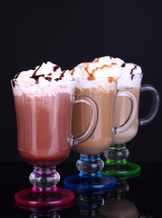 Layered coffee in glass on table on grey background