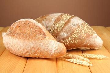 Composition with bread on wooden table, on color background