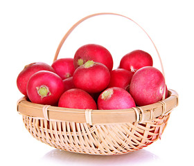 Small garden radish in wicker basket isolated on white