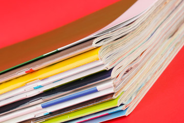 Many magazines on red background