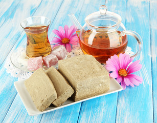 Tasty halva with tea on table