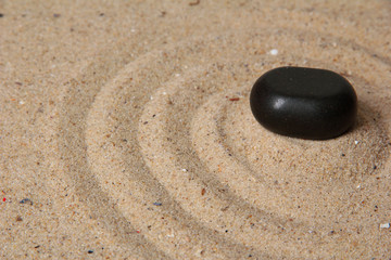Zen garden with raked sand and stone close up