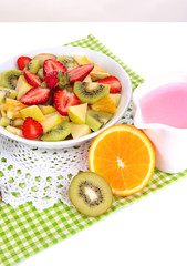 Fototapeta na wymiar Useful fruit salad of fresh fruits and berries in bowl isolated