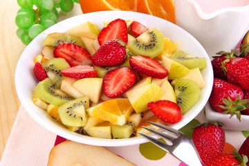 Useful fruit salad of fresh fruits and berries in bowl