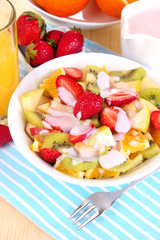 Useful fruit salad of fresh fruits and berries in bowl